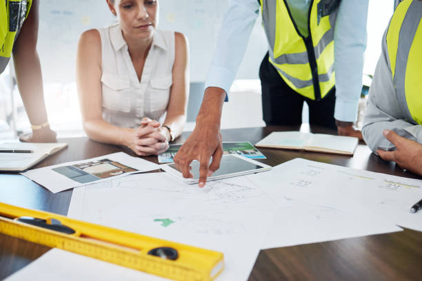 sintirisikaiepistekeues Construction, blueprint and planning with architect in meeting for consulting, project management and vision. Design, engineering and construction site plans with team of designers or contractors