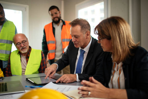 sumvouleutiki Board directors having a meeting with the team in the office at the construction site